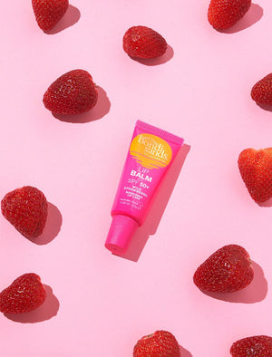 SPF 50+ Lip Balm Wild Strawberry Image with Strawberries
