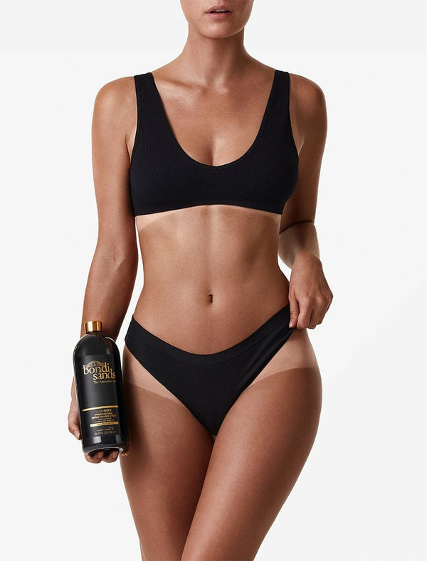 Front image of model holding Salon Solution Liquid Gold