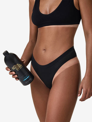 Close up front image of model holding Salon Solution Ultra Dark