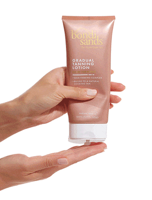 Squeeze of skin firming gradual tanning lotion onto hands